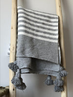 Plaid gris à rayures et pompons